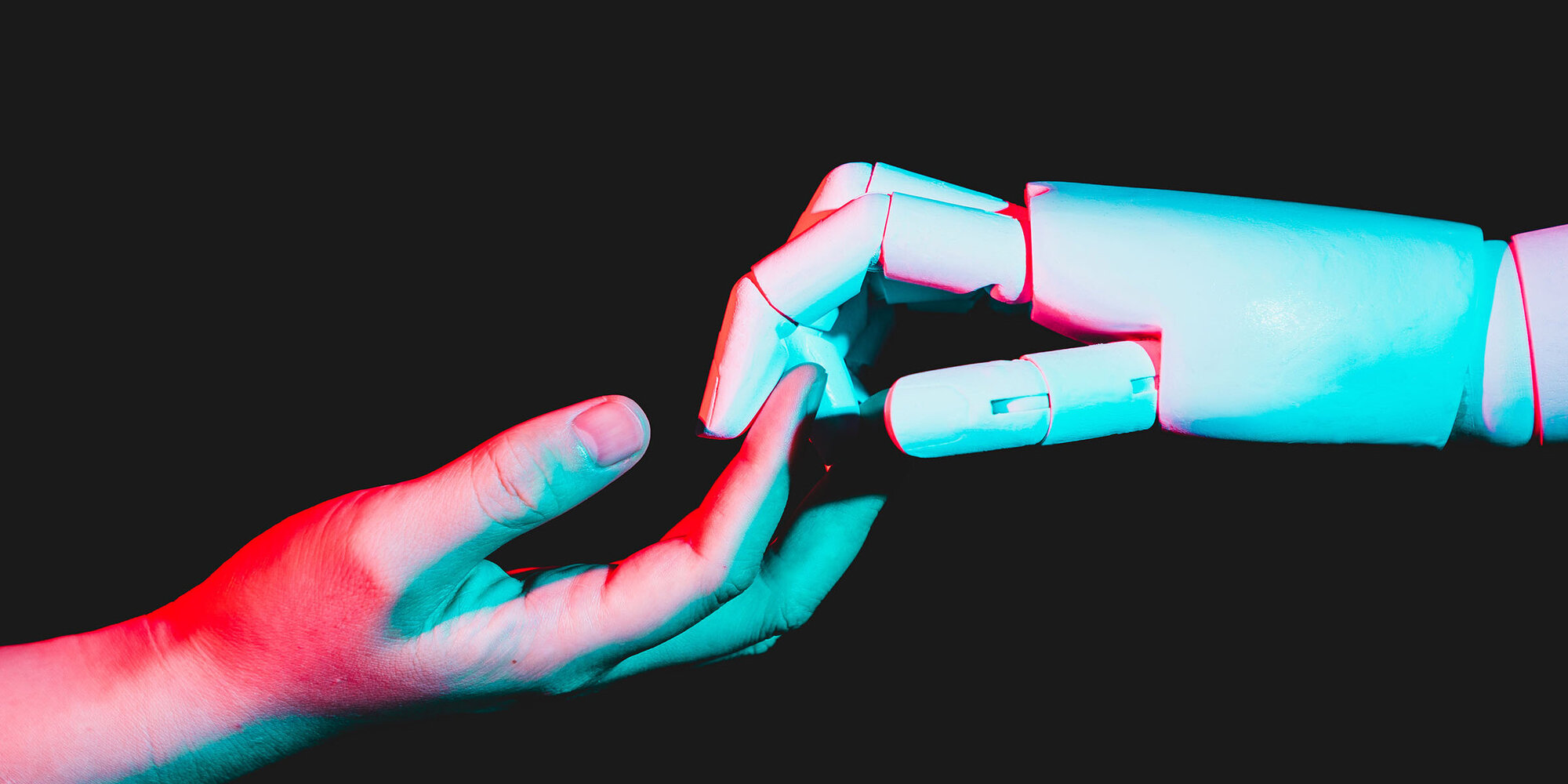 human hand touching robotic hand