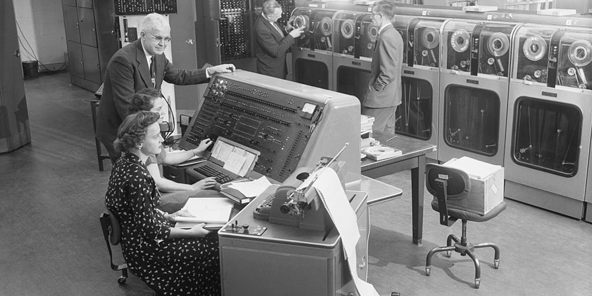 For the first time in history, the US Census Bureau begins tabulating results of the 1954 Census of Business with the UNIVAC, a giant electronic computing system. At the computer instrument panel are (front to back) Clydia Beeps, Maxine C. Warner, and the Deputy Director of the Bureau of Census, A. Ross Echler.